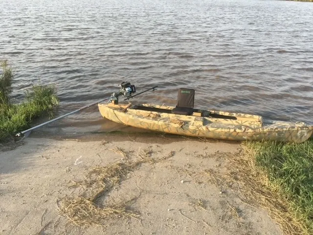 Carstens Pintail with a homemade motor mount sitting in the water at a boat ramp.